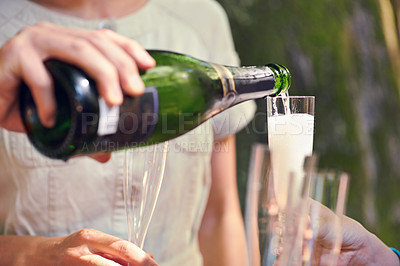 Buy stock photo Hand, pour champagne and glasses for group of friends for celebration, toast and party in park, garden or nature. Bottle, sparkling wine and glass to celebrate for team of people, birthday or event