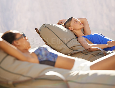 Buy stock photo Women, swimwear and lounge chairs for poolside, relax or tanning during summer vacation in Australia. Diverse, female tourists and lying down at holiday resort, wellness spa and luxury hotel