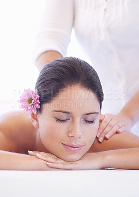 Buy stock photo Relax, massage and woman at wellness spa with flower for health, rest and luxury holistic treatment. Self care, peace and girl on table with masseuse for body therapy, balance and calm hotel service