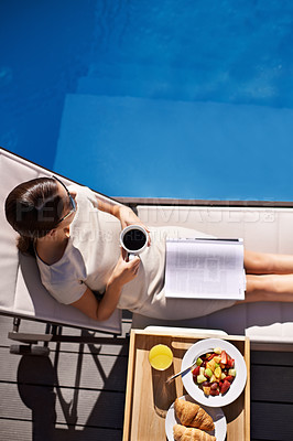 Buy stock photo Top view of an attractive young woman enjoying her breakfast by the pool