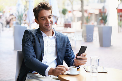 Buy stock photo Phone, smile and business man at coffee shop outdoor for communication, networking or text message. Cafe, smile and mobile with happy young employee drinking caffeine beverage at table as customer