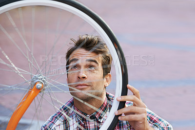 Buy stock photo City, check and man with bicycle wheel, sunshine and road with guy and transportation with sustainability. Bike inspection, person and hipster with maintenance and eco friendly with cycling and Italy