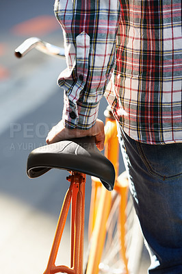 Buy stock photo Hands, person and push bike in city to travel on eco friendly transport outdoor, commute or walk. Cycling, back or bicycle in urban town, street or road for journey with rear view of seat on sidewalk