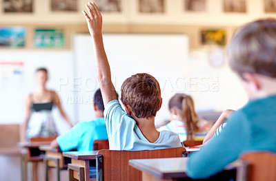 Buy stock photo Question, student and hand raised for help in classroom, solution and boy at school. Male person, back and curious for answer or information, learning and study or education for growth in childhood