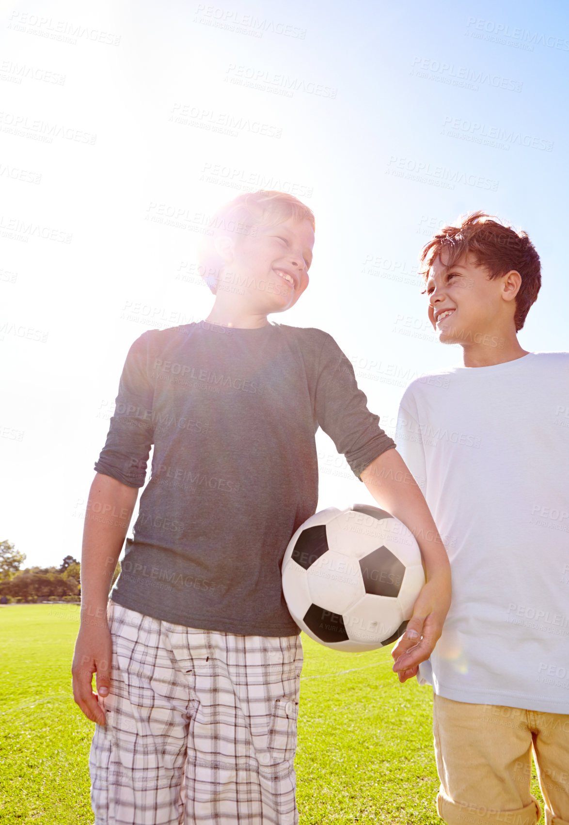 Buy stock photo Soccer, friends and playing with ball on field, support and smile for sports game on grass. Boys, children and performance on outdoor pitch, bonding and pride for collaboration in football challenge