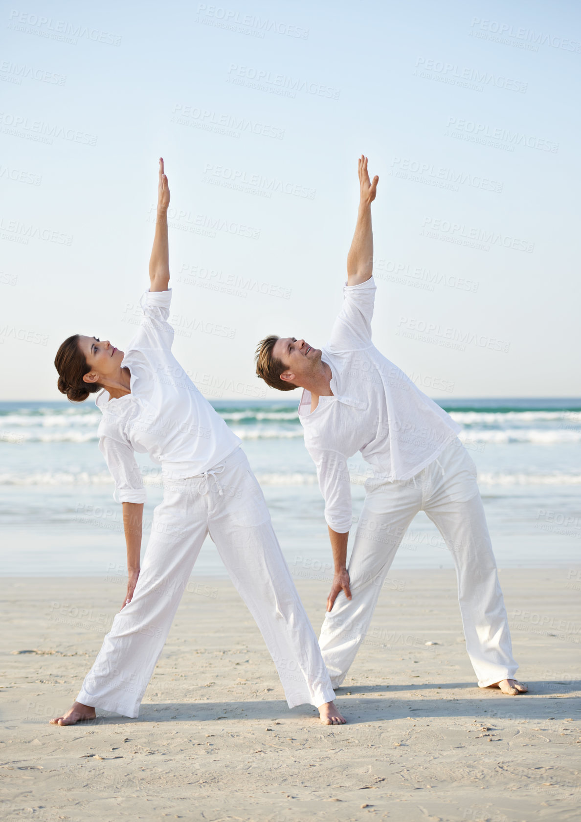 Buy stock photo Stretching, yoga and couple on beach in morning for fitness, exercise and workout for performance. Nature, love and man and woman by ocean for pilates, wellness and healthy body outdoors together