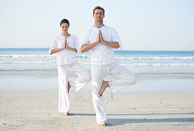 Buy stock photo Couple, yoga and balance, meditation on beach for zen and wellness, travel and mindfulness with holistic healing. People outdoor, exercise and peace, workout together for bonding with sea and nature