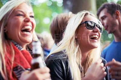 Buy stock photo Happy, drinks and women at music festival, concert or party laughing, excited and enjoy outdoor rave or techno celebration. Young friends, audience or crowd with beer bottle or alcohol for holiday