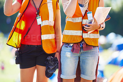 Buy stock photo Hands, festival and event security with people outdoor on campsite together for safety or crowd control. Camping, concert or reflective vest with person and partner on grass for community patrol