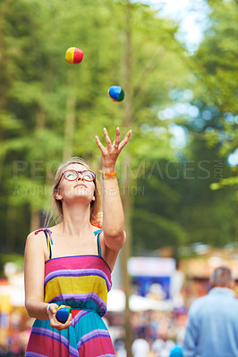 Buy stock photo Camping, festival and juggle with woman in park for event, party or celebration in summer environment. Nature, forest or woods with young person in glasses juggling balls outdoor at social gathering