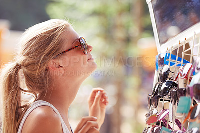 Buy stock photo Woman, buying sunglasses and shopping at market outdoor in summer with consumer at flea store. Sales, person and purchase shades at shop, decision and retail choice of customer trying eyewear gift