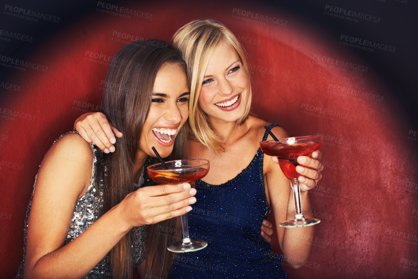 Buy stock photo Two gorgeous young woman enjoying cocktails