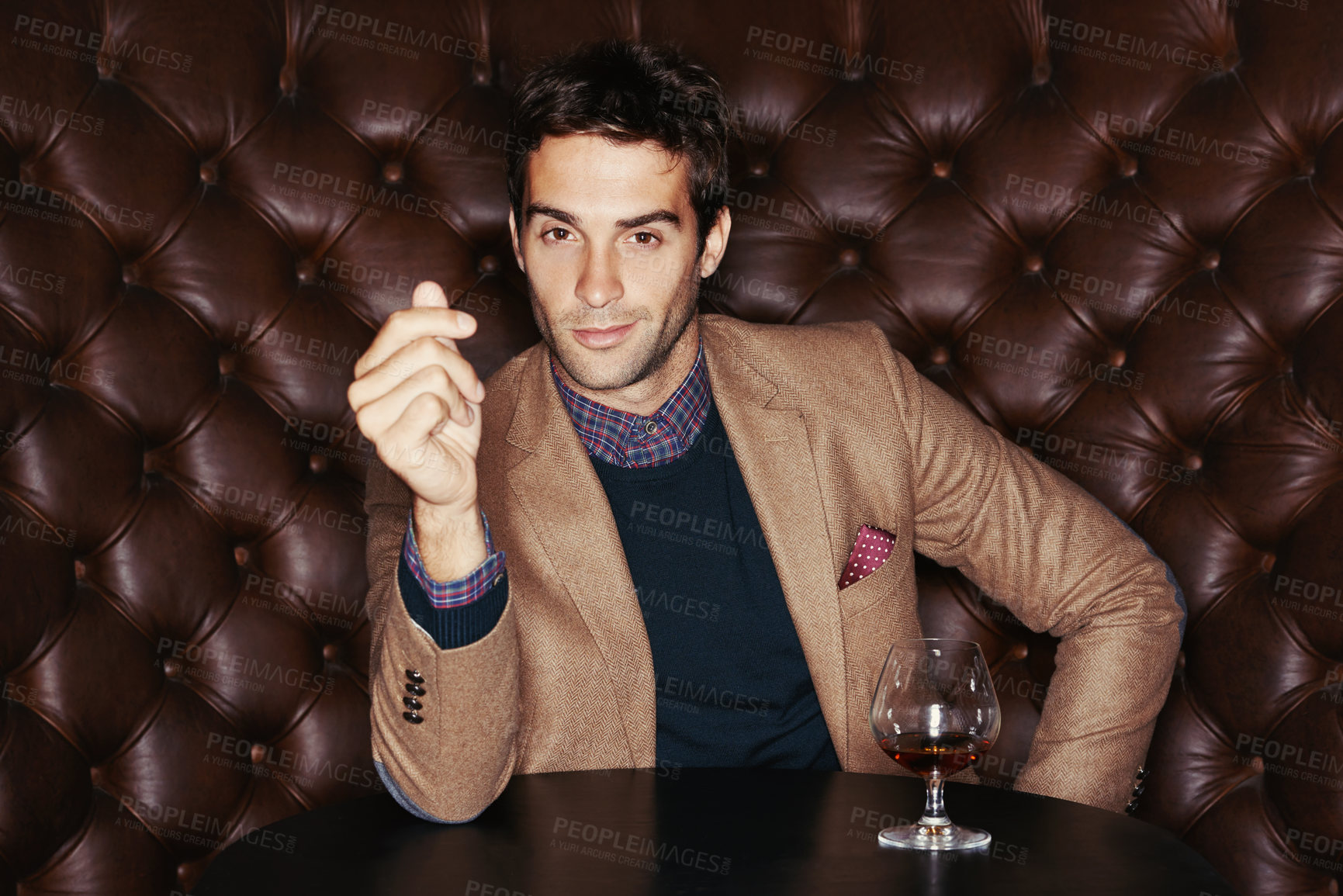 Buy stock photo Portrait of a handsome young man drinking in a club