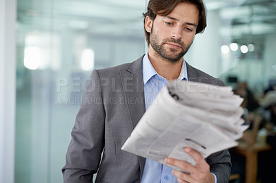 Buy stock photo Cropped view of a businessman reading the finance section of a newspaper