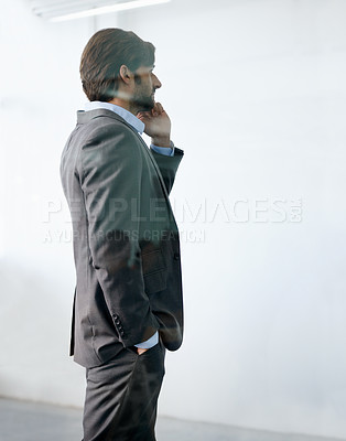Buy stock photo A handsome young businessman communicating via cellphone
