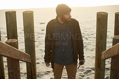Buy stock photo Cropped shot of a bearded man standing on the beach