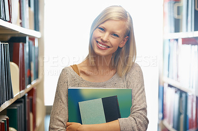 Buy stock photo Woman, library and book, portrait with story for education and knowledge with smile on campus. Student, bookstore and reading material for learning, happy with university and academic development
