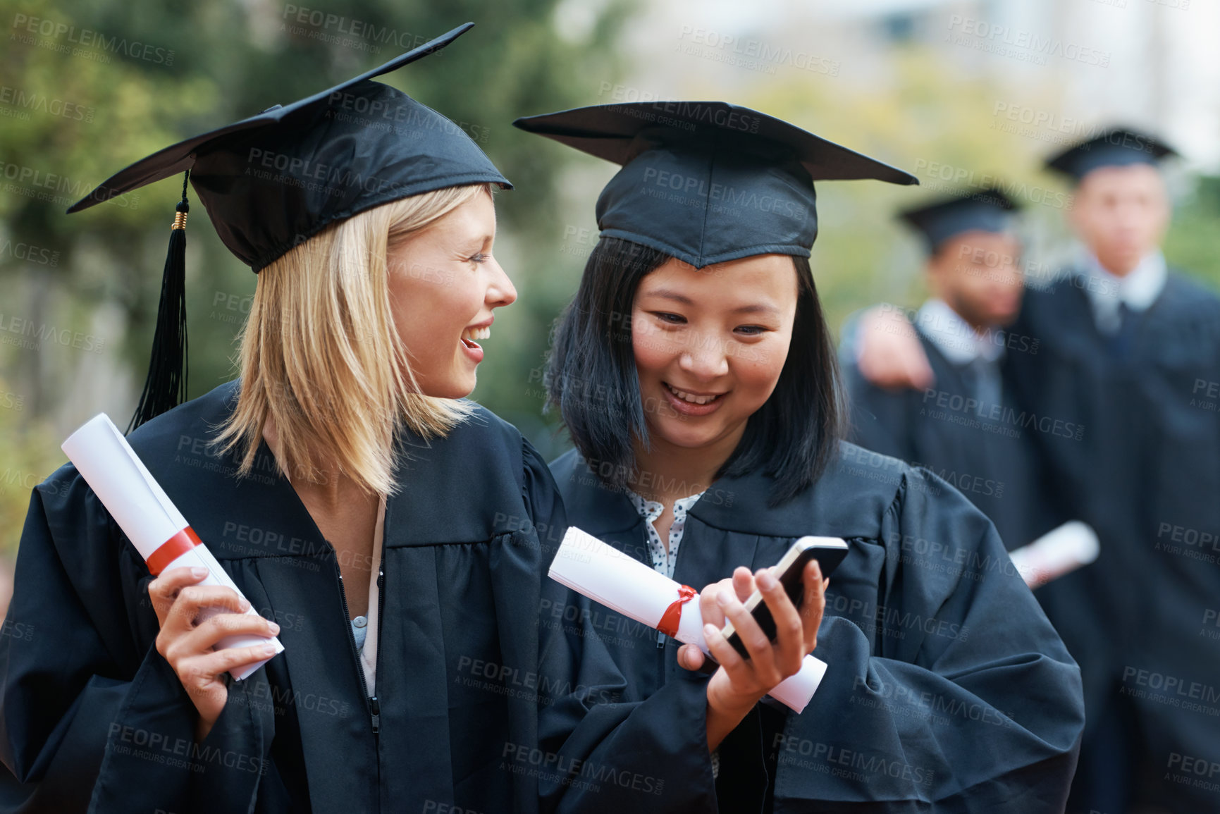 Buy stock photo Phone, graduation and students in college or university to celebrate school diploma or degree. Mobile app, happy graduate friends or women with education certificate for goal notification or news
