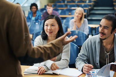 Buy stock photo Cropped shot of a group of university students listening to their lecturer