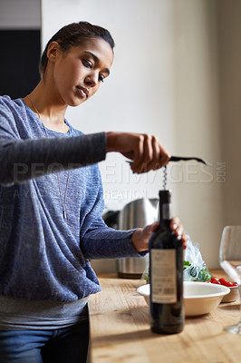 Buy stock photo Woman, open wine and bottle for dinner, evening meal with corkscrew and preparing to drink for enjoyment and nutrition. Alcoholic beverage, tools or equipment with cooking for dining in kitchen