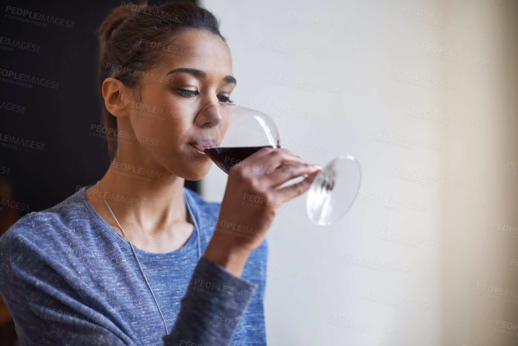 Buy stock photo Woman, drinking red wine and home to relax for peace and leisure with alcoholic liquid in kitchen. Tasting alcohol, glass and refreshment, hydration with beverage to celebrate or chill in apartment