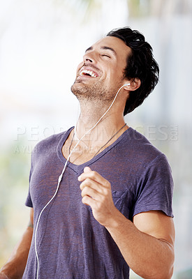 Buy stock photo Man, happy and earphones with laugh for podcast, radio or online streaming with confidence. Male person, smile and face with listening to audio on headphones for subscription, wellness and enjoyment