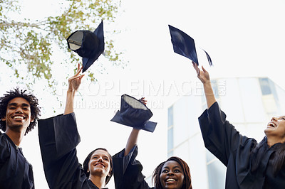 Buy stock photo Happy people, students and hats in celebration for graduation, winning or achievement at campus. Group of graduates throwing caps in air for certificate, education or milestone at outdoor university