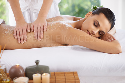 Buy stock photo Shot of a young woman enjoying a massage at a spa