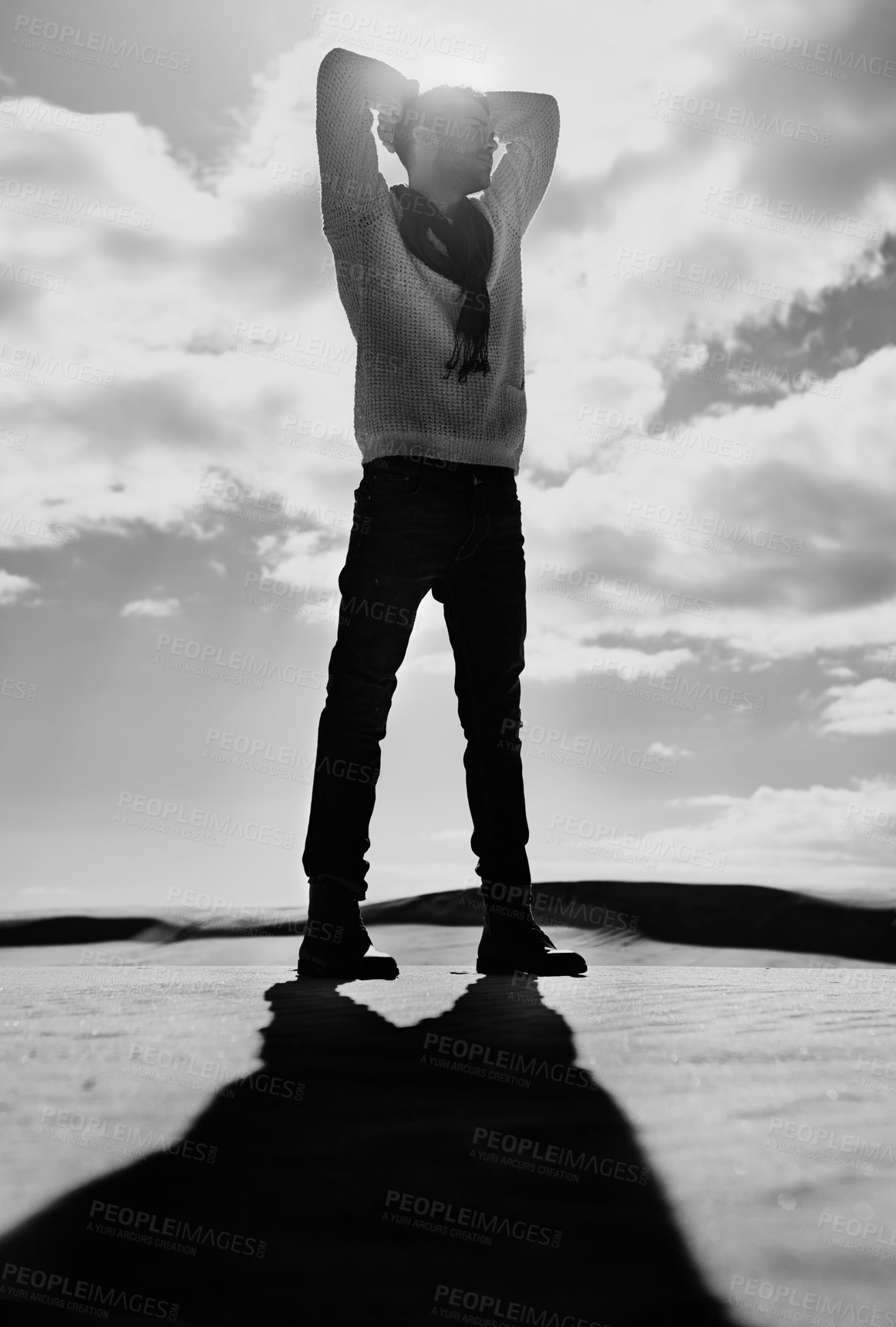 Buy stock photo Full length monochrome shot of a man standing in a desert landscape