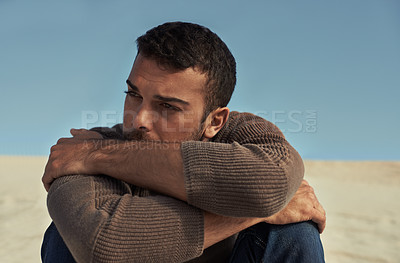 Buy stock photo Depressed, model or man in the desert thinking of travel in summer sitting on holiday vacation. Upset, worry or stress with face of nervous person on the ground or sand dunes with anxiety or fear