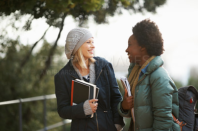 Buy stock photo Women, university student and friends with book on campus for sharing, information and notes on research. Classmates, campus and knowledge with advice to prepare for assignment submissions. 