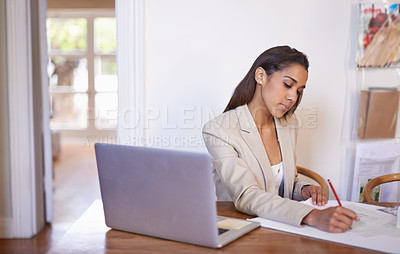 Buy stock photo Shot of a young fashion designer working on some sketches