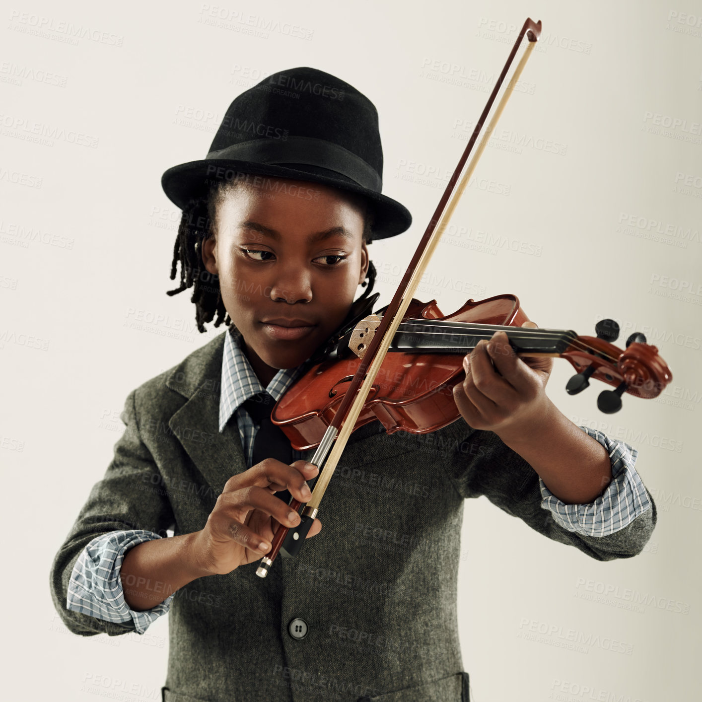 Buy stock photo A young African-American boy playing a violin