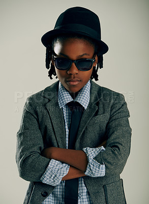 Buy stock photo Sunglasses, fashion and kid with arms crossed in studio for stylish suit isolated on a grey background. Face, confidence and serious African child in hat, cool or black boy in trendy clothes in Kenya