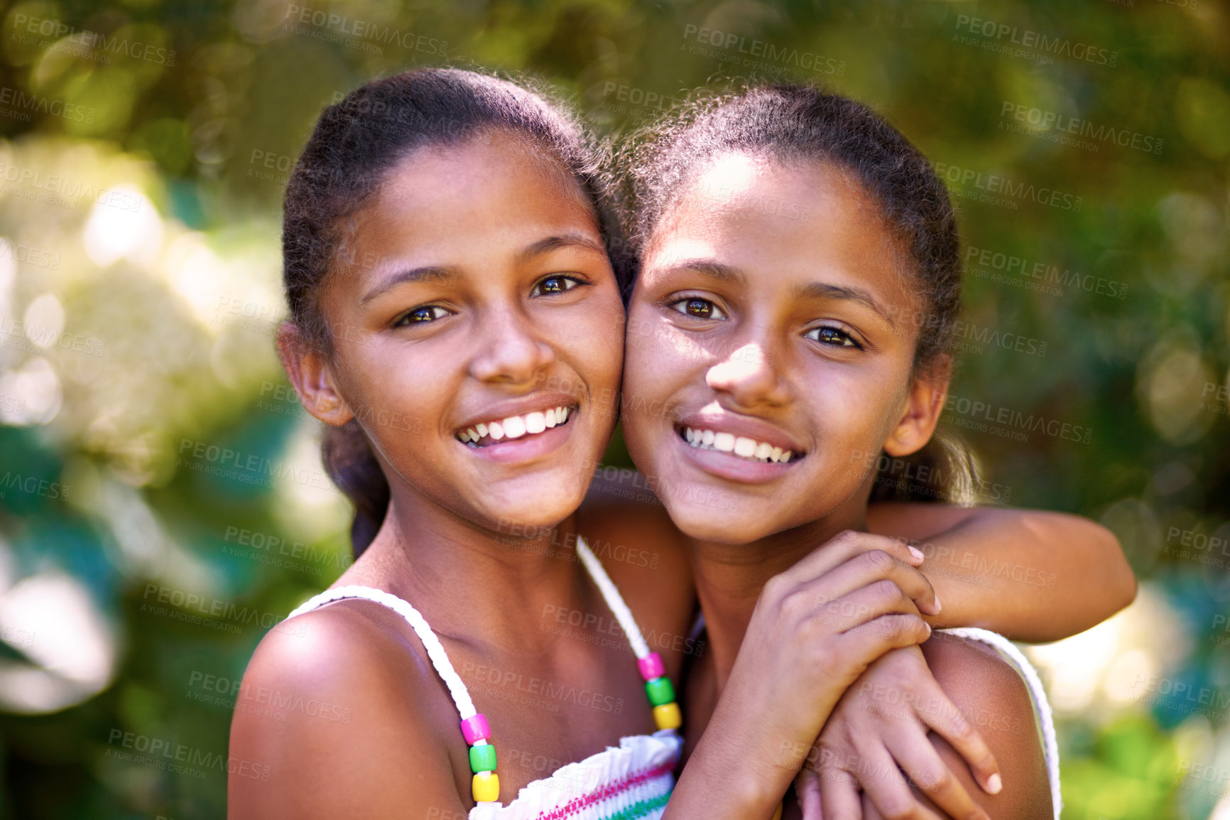 Buy stock photo Portrait of two twin sisters standing together outside