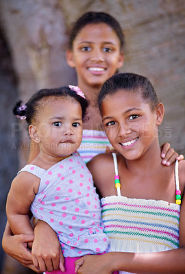 Buy stock photo Cropped portrait of three young sisters standing together outside