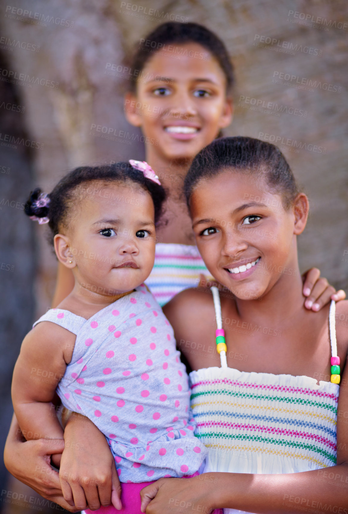 Buy stock photo Cropped portrait of three young sisters standing together outside