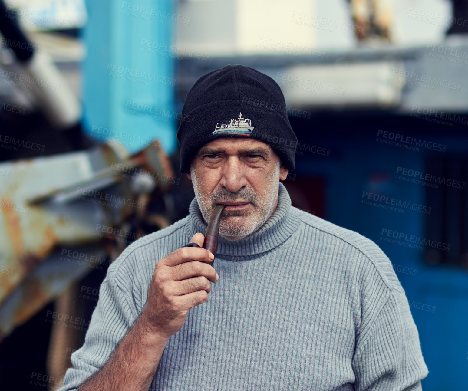 Buy stock photo Cropped shot of an elderly fisherman smoking his pipe
