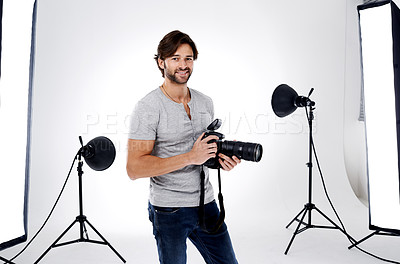 Buy stock photo Photographer, portrait and smile with camera in studio for career, behind the scenes and backpack. Photography, person or happy with equipment, mockup space or shooting gear for photoshoot or passion