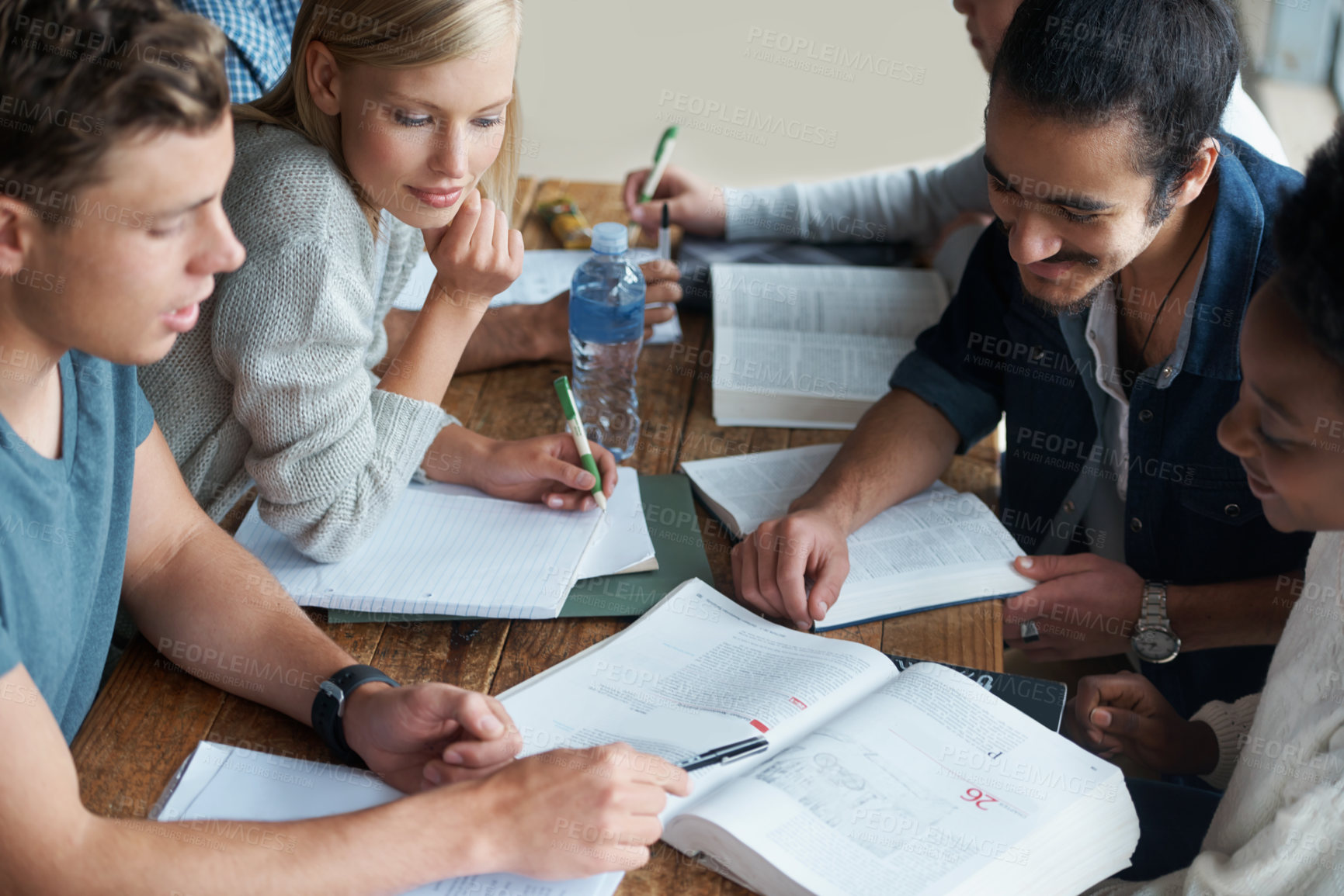 Buy stock photo A group of college students sitting together and studying