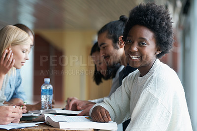 Buy stock photo A group of college students sitting together and studying