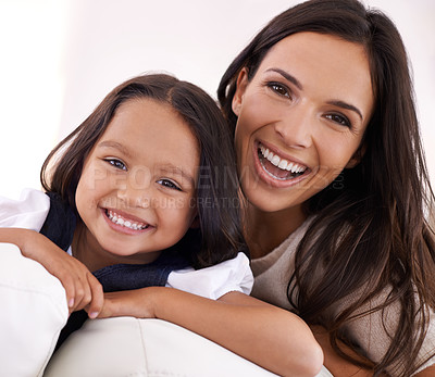 Buy stock photo Happy mother, portrait and child on sofa for love, bonding or care together at home. Face of mom, parent and little girl, daughter or young kid with smile in living room for family weekend or holiday
