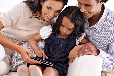 Buy stock photo Happy family, tablet and sofa for entertainment, social media or reading ebook together at home. Mother, father and daughter on technology for online streaming, movie or internet on couch at house