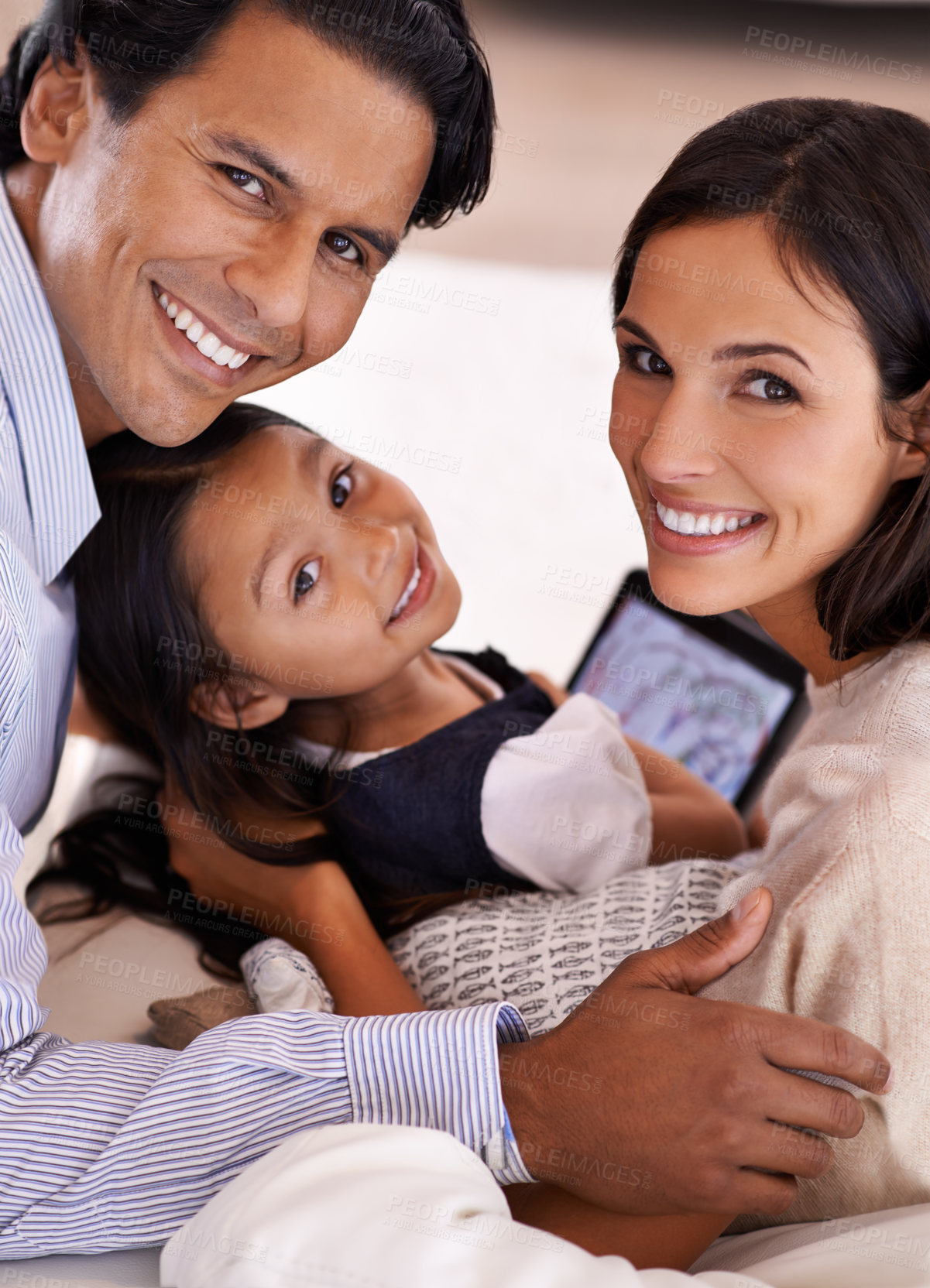 Buy stock photo Cropped portrait of an affectionate young family sharing a digital tablet