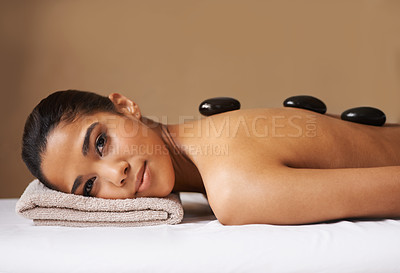 Buy stock photo Portrait of girl, rock or back massage in spa to relax for zen, resting or wellness physical therapy. Face of female client in salon to exfoliate for natural skincare healing treatment or hot stone 