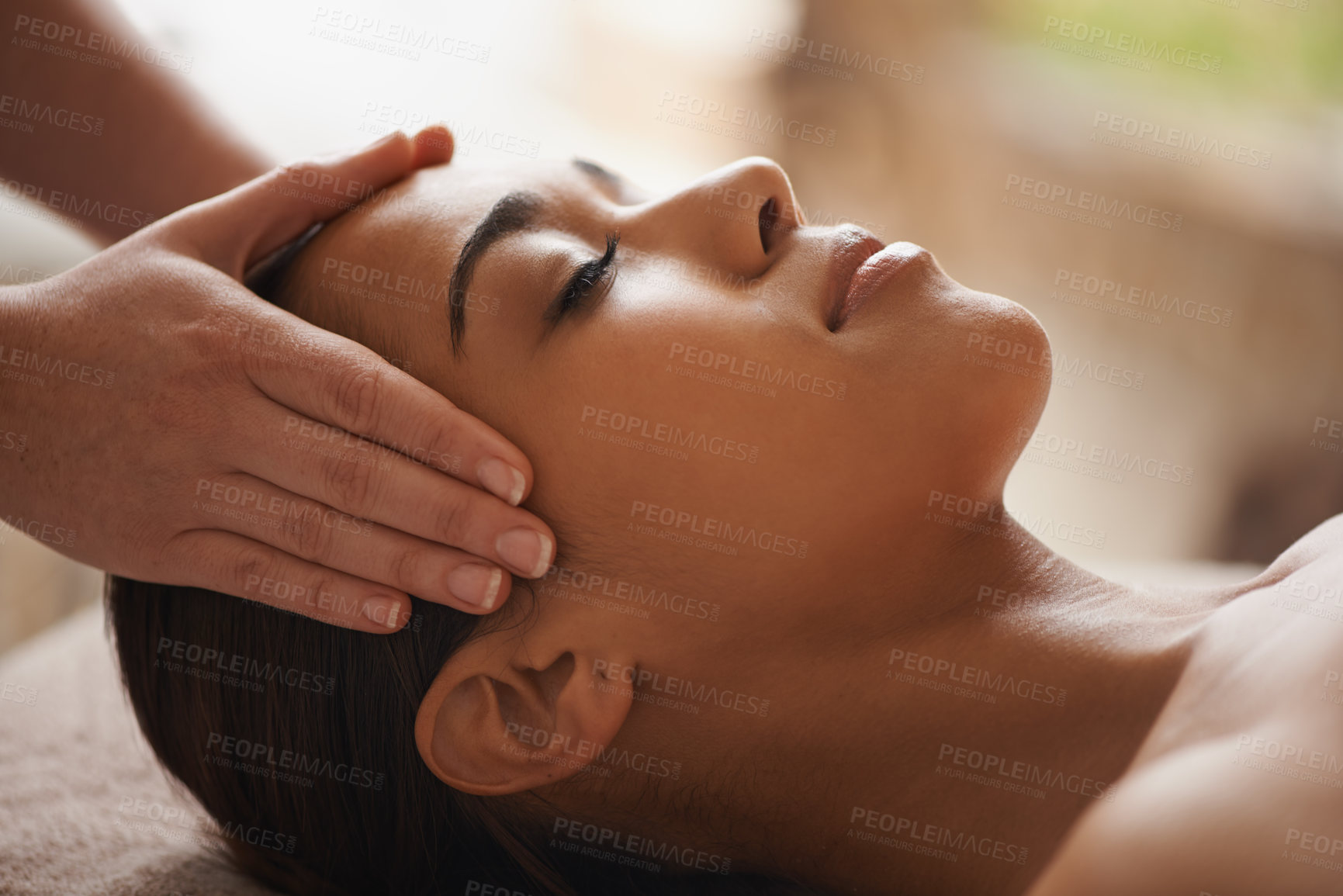 Buy stock photo Shot of a beautiful young woman getting a head massage at a spa