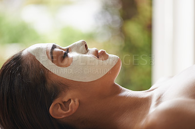 Buy stock photo Skincare, cosmetic and woman with face mask at spa for glow, wellness and beauty routine with peace. Natural, pamper and female person relaxing for clay facial dermatology treatment at salon.
