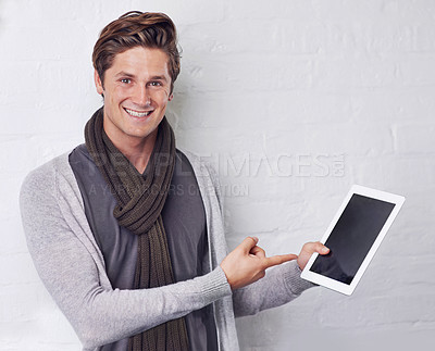 Buy stock photo Happy man, portrait and pointing to tablet screen for advertising or marketing on a white studio background. Young and handsome male person with smile, showing technology display or mockup space