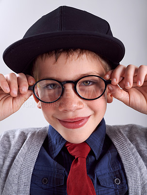 Buy stock photo Glasses, smile and portrait of child in studio for eye care, vision and optical health. Happy, optometry and cute young boy kid with stylish eyewear or spectacles isolated by gray background.