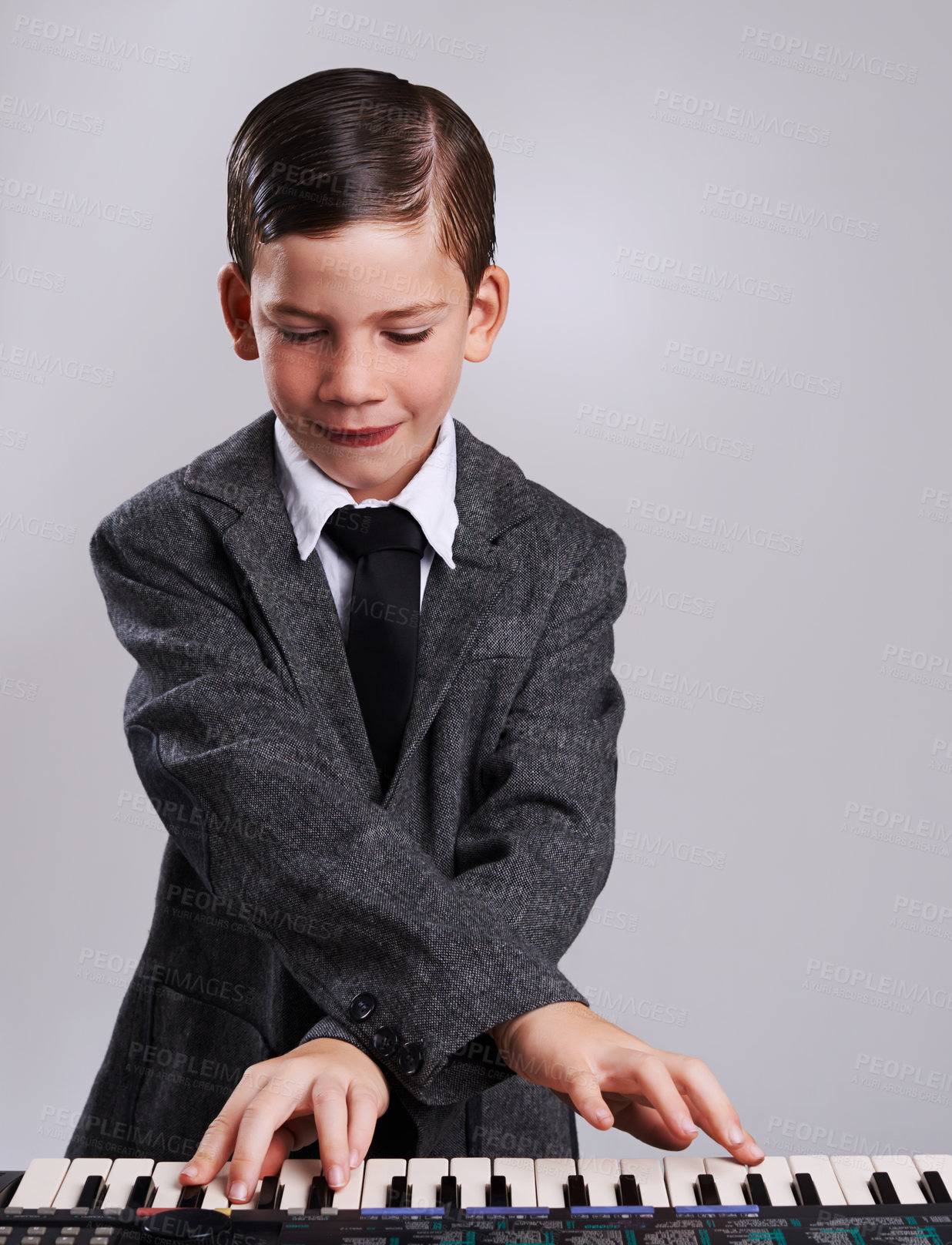 Buy stock photo Studio shot of a young musician dressed in a suit